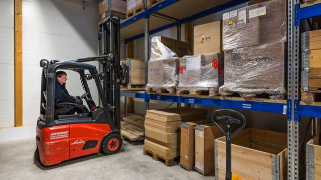 Photograph: Moving stock in the warehouse at SI Technik Headquarters